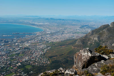 High angle view of city by sea against sky