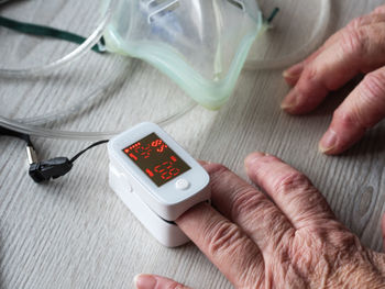 Cropped hands of woman checking pulse trace