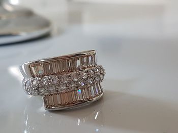 Close-up of wedding ring on table