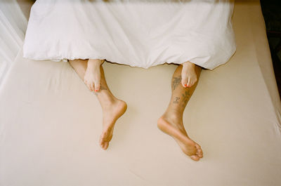 Low section of couple in bed