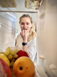 Portrait of young woman in kitchen