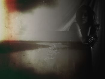 Woman standing by wall