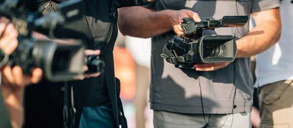 Television cameras at a press conference outdoors