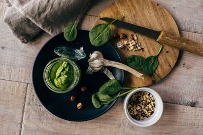 High angle view of served pesto sauce with garlic on table