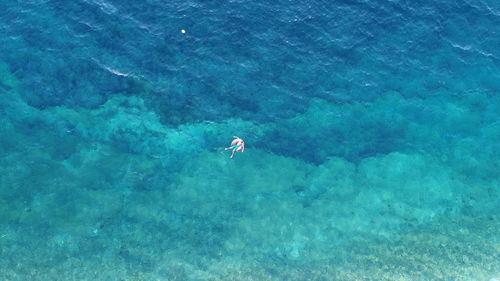 High angle view of people swimming in sea