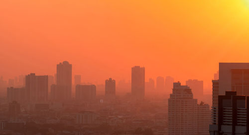 Air pollution in bangkok, thailand. smog and fine dust of pm2.5 covered city with sunrise sky. 