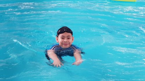 High angle view portrait of boy swimming in pool