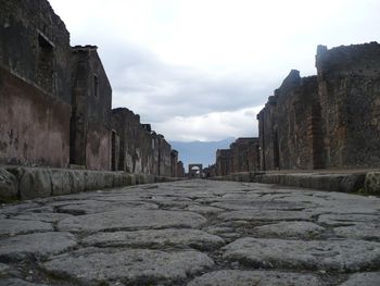 Surface level view of cobblestone street in pompeii