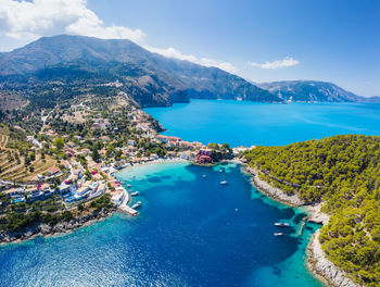 High angle view of sea and mountains against sky