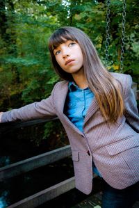 Portrait of beautiful young woman in forest