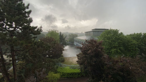 High angle view of trees and buildings against sky