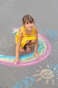 Portrait of cute girl playing on road