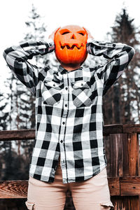 Midsection of man standing against wall during halloween