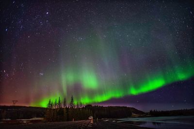 Scenic view of northern lights and star field at night