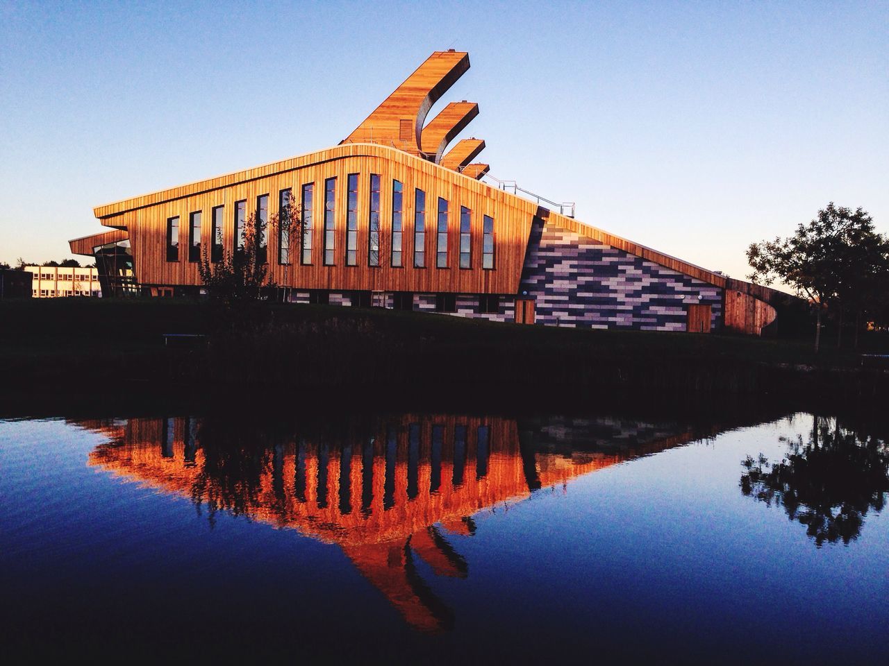 Reflection of bridge in water against sky