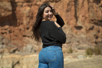 Portrait of a smiling young woman standing outdoors