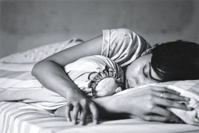 Woman sleeping on bed at home