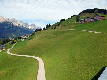 Scenic view of landscape and houses against sky