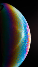 Close-up of rainbow against black background