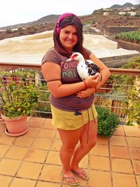 Portrait of a smiling young woman standing outdoors