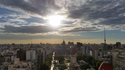 High angle view of city buildings against sky during sunset