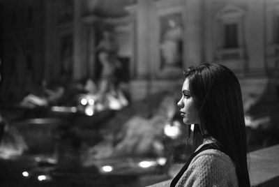 Side view of young woman against blurred background