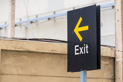 Close-up of arrow sign on wall