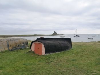 Built structure on field against sky