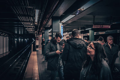 People waiting at railroad station platform