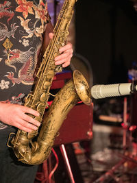 Midsection of man playing drum