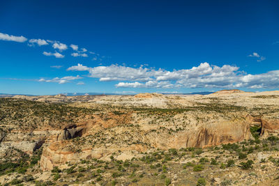 Scenic view of desert against blue sky