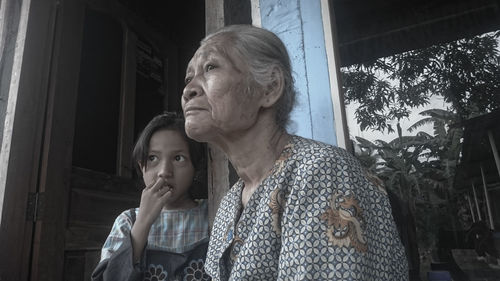 Close-up of grandmother and granddaughter outside house