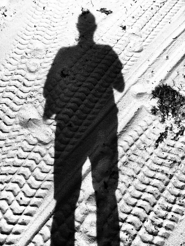 shadow, focus on shadow, sunlight, textured, street, high angle view, silhouette, cobblestone, built structure, pattern, outdoors, day, architecture, paving stone, wall - building feature, unrecognizable person, building exterior, sidewalk, close-up, footpath