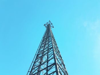 Low angle view of communications tower against blue sky