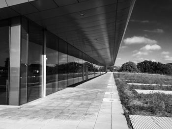 Empty road leading towards building