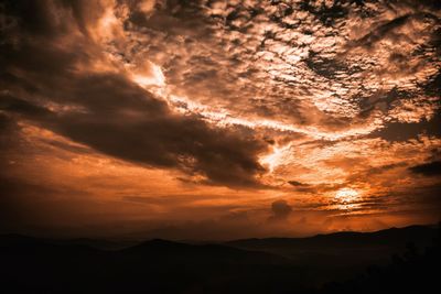 Low angle view of dramatic sky during sunset