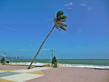 Scenic view of beach against blue sky