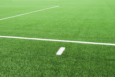 White lines on football playground. lines in field. plastic grass and finely ground black rubber.