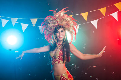 Beautiful young woman dancing in traditional clothing