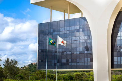 Low angle view of flag on building against sky