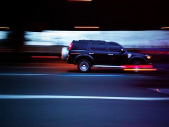 Blurred motion of car on road at night