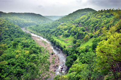 Scenic view of waterfall against sky