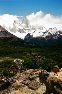 Scenic view of mountains against cloudy sky