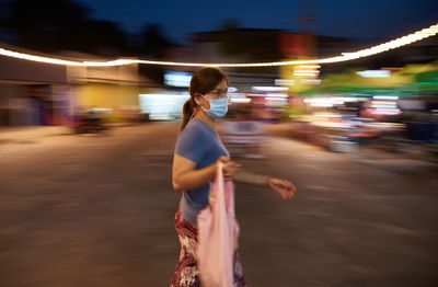 Blur motion of woman walking in the market during covid-19 disease
