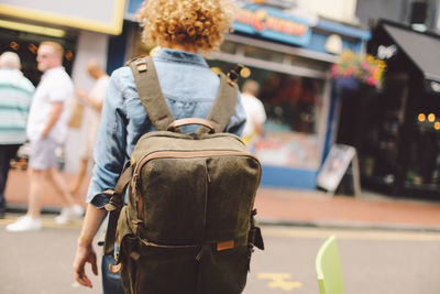 Rear view of woman walking on street in city