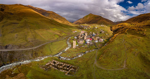 Scenic view of landscape against cloudy sky