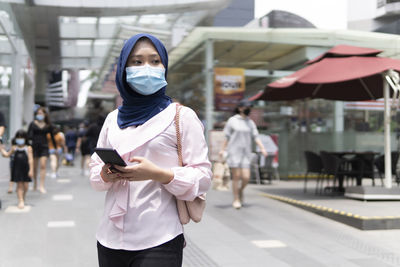 Portrait of woman standing on street