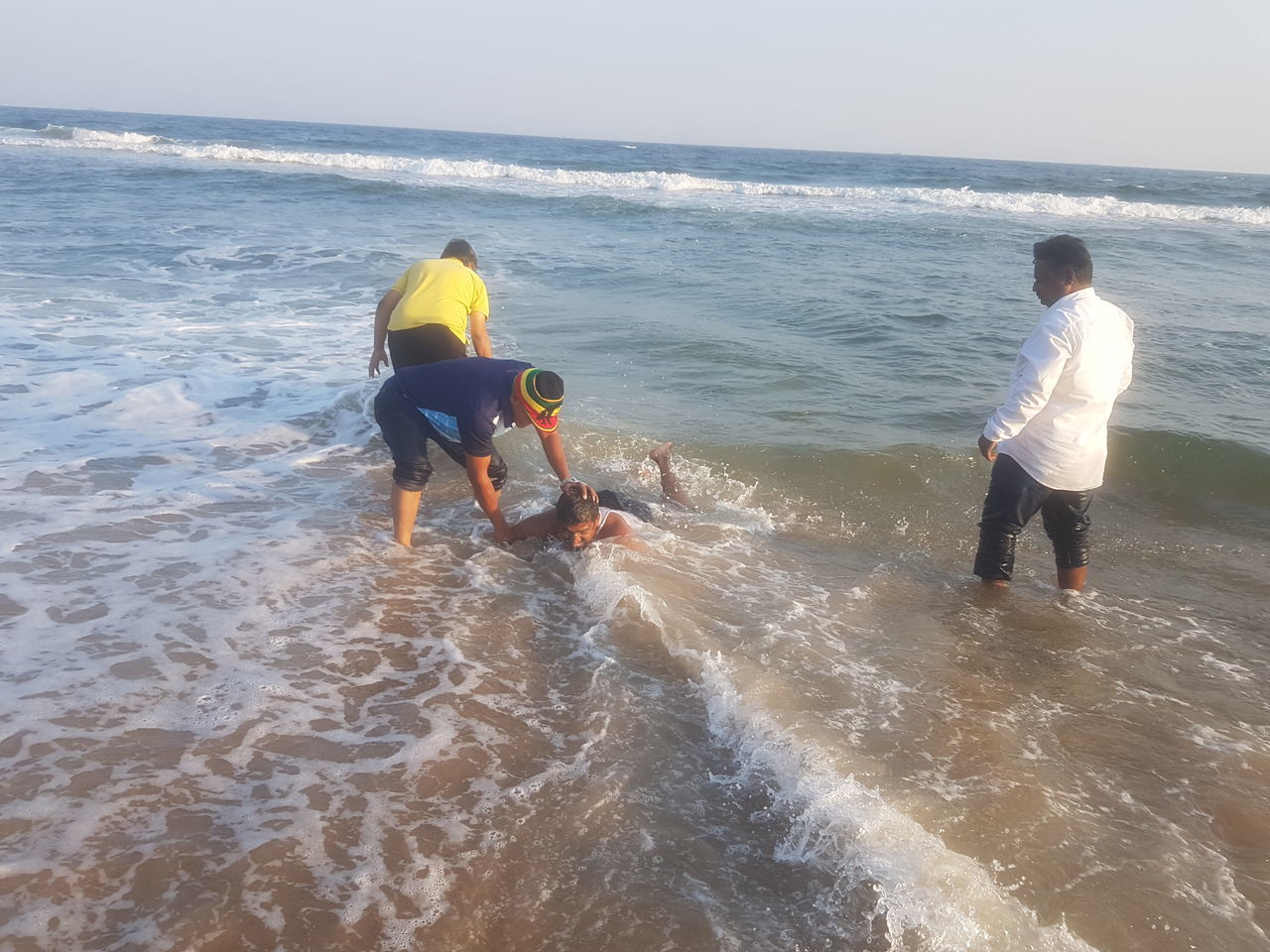 REAR VIEW OF FRIENDS ON BEACH