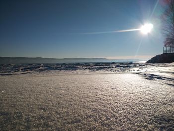 Scenic view of sea against clear sky during sunny day