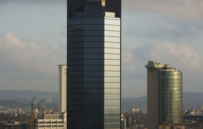 Modern buildings in city against sky